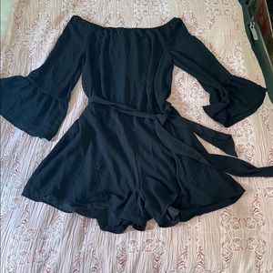 Fun little black romper with elegant fit. Size M.